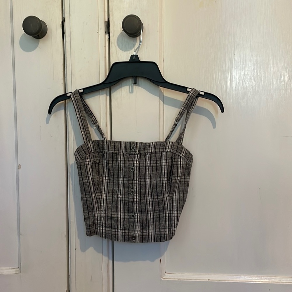 Plaid style tank top, grey white and black colored.
